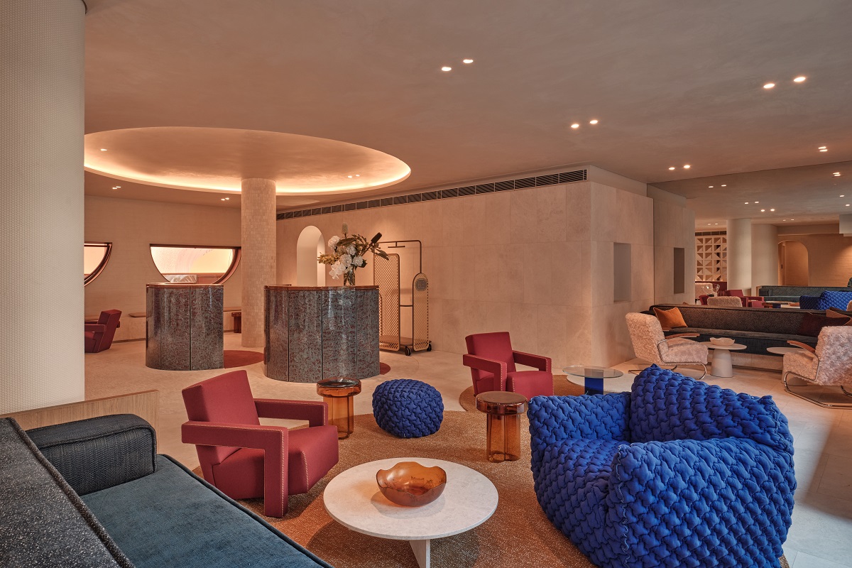 blue and rust chairs in cream interior in lobby of The EVE Sydney