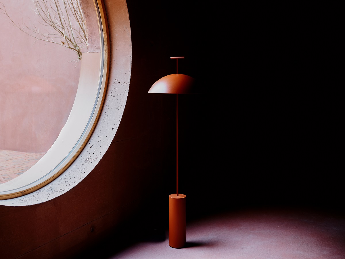 burgundy wall, porthole concrete window and minimalist lighting design in Hôtel Borsari