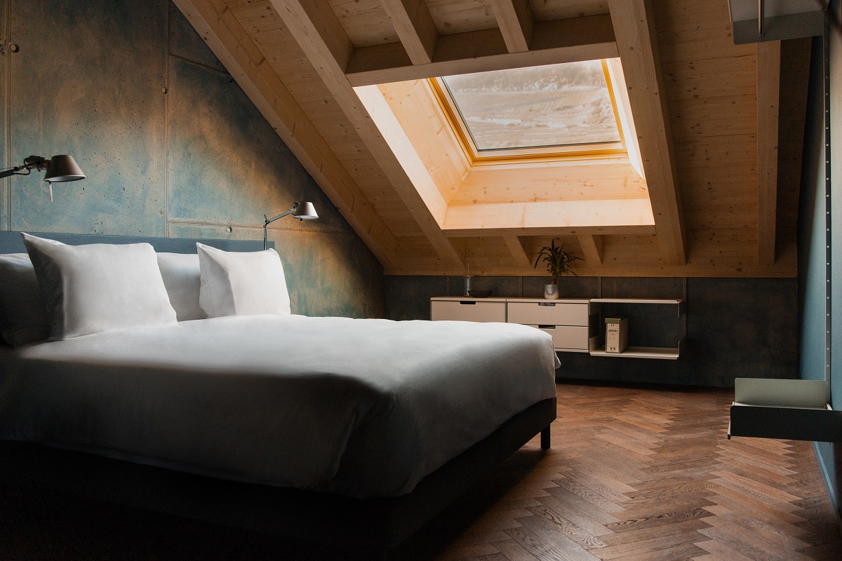 bedroom with skylight over swiss landscape