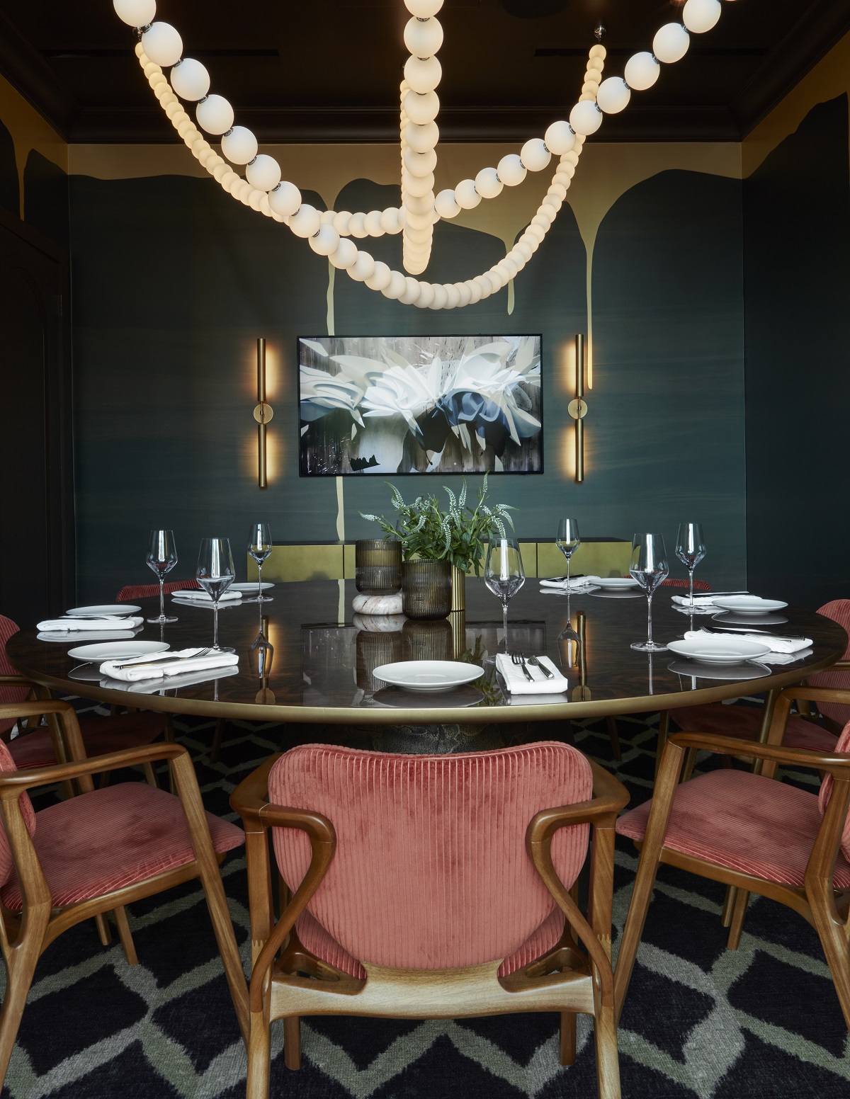 beaded statement lighting above round dining table in private club