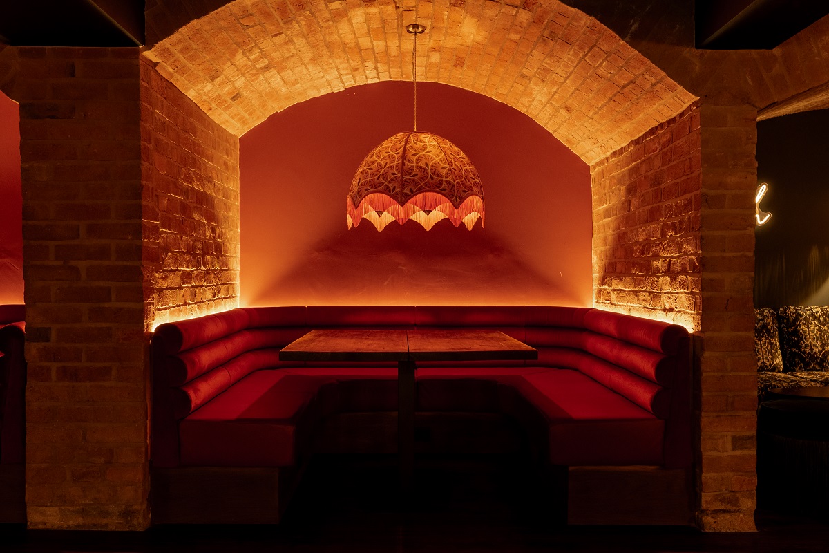 brick alcove in cellar transformed by Black Ivy Design into a bar