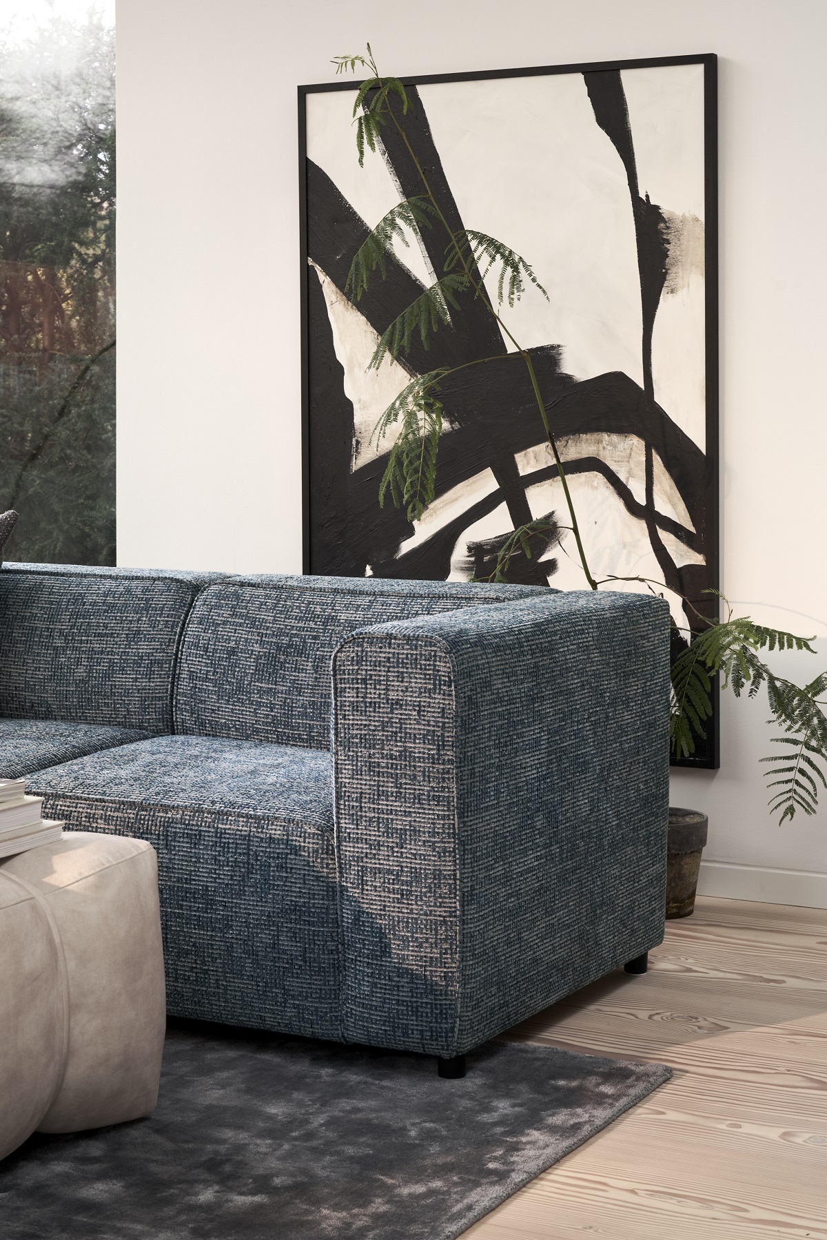 Carmo couch in front of black and white abstract painting
