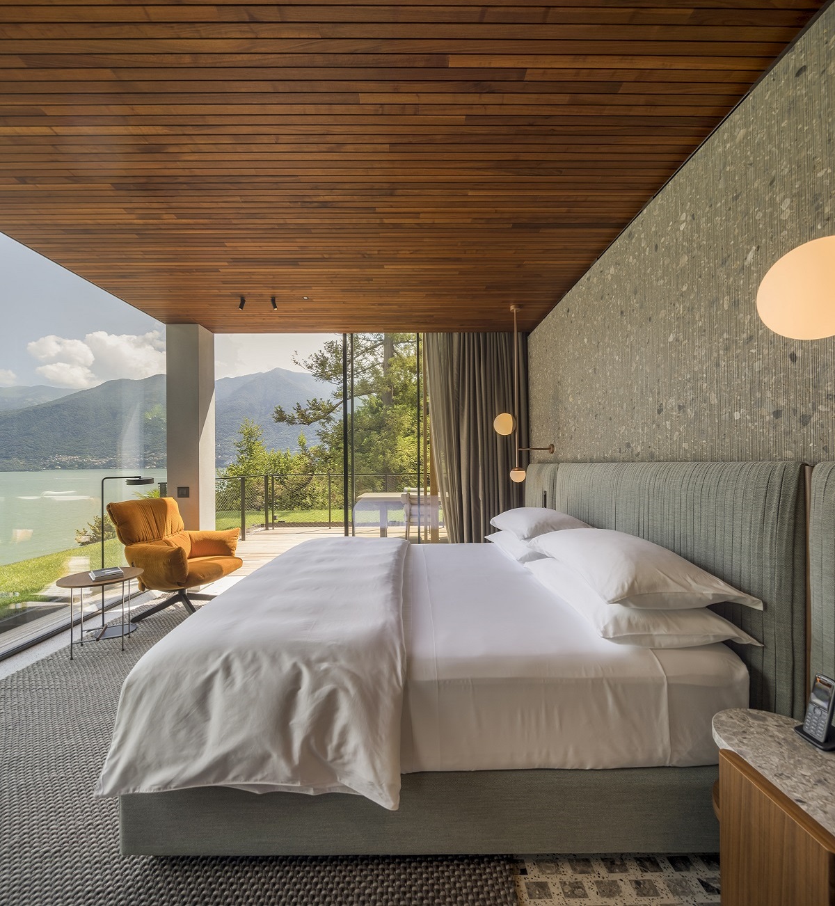 bed in hotel guestroom with view across lake como