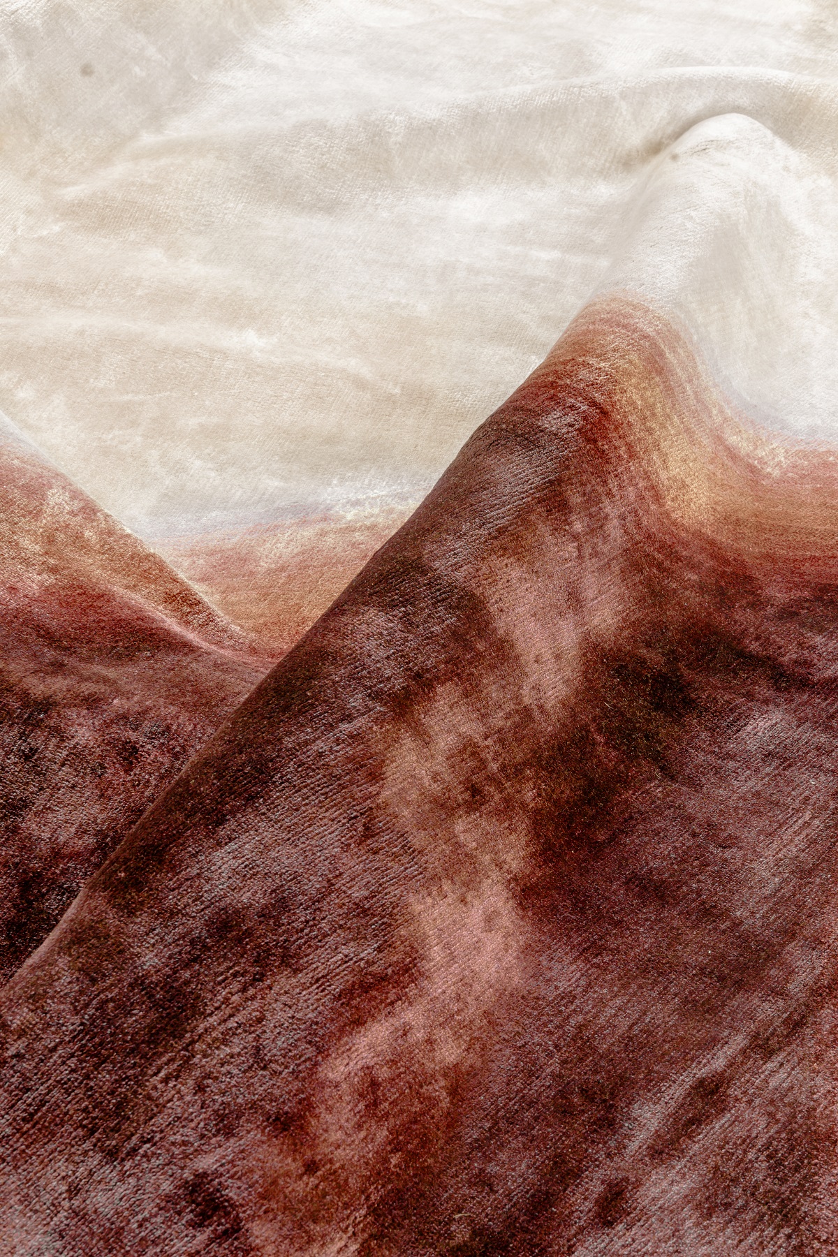 detail and fold of woven brown and cream carpet