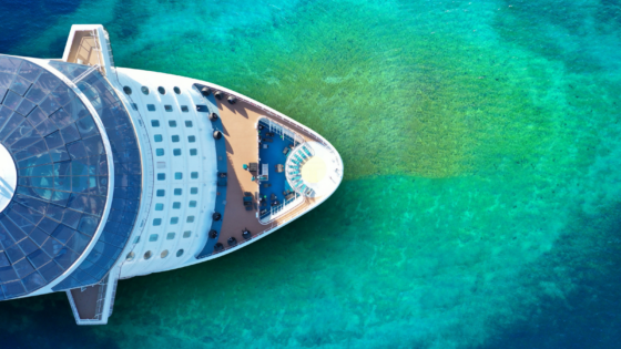 Birds-eye-view of cruise ship on turquoise green sea