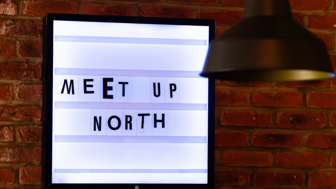 MEET UP North text in cut out newspaper style font on light box