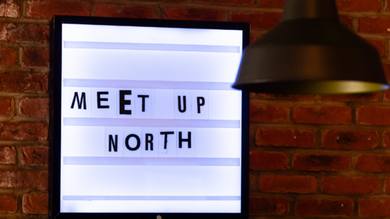 MEET UP North text in cut out newspaper style font on light box