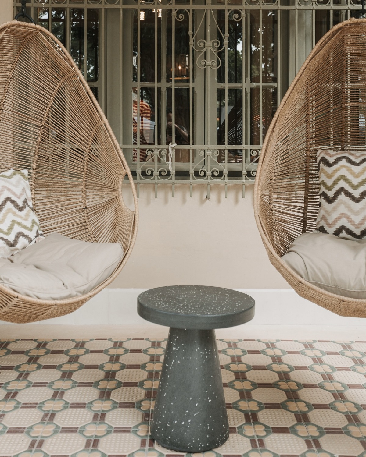 hanging basket seats with patterned cushions and tiles