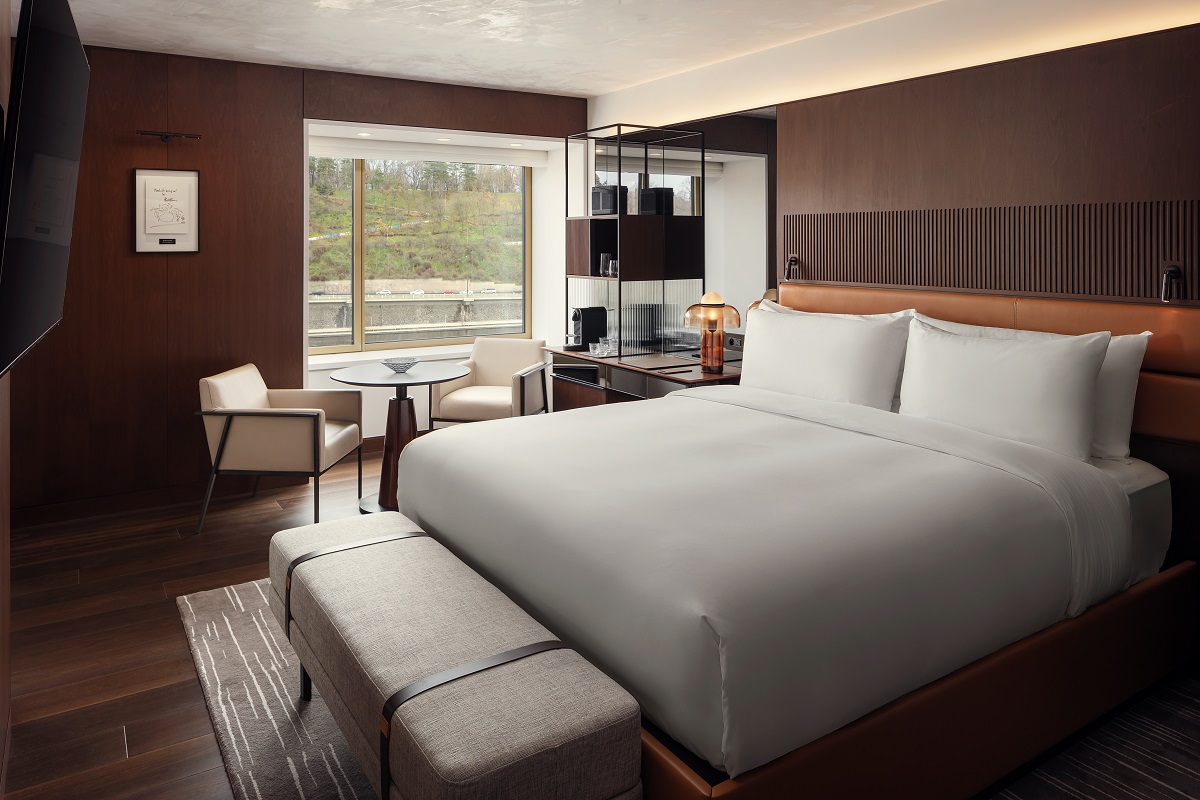 white bed linen and dark walls in Fairmont Prague guestroom