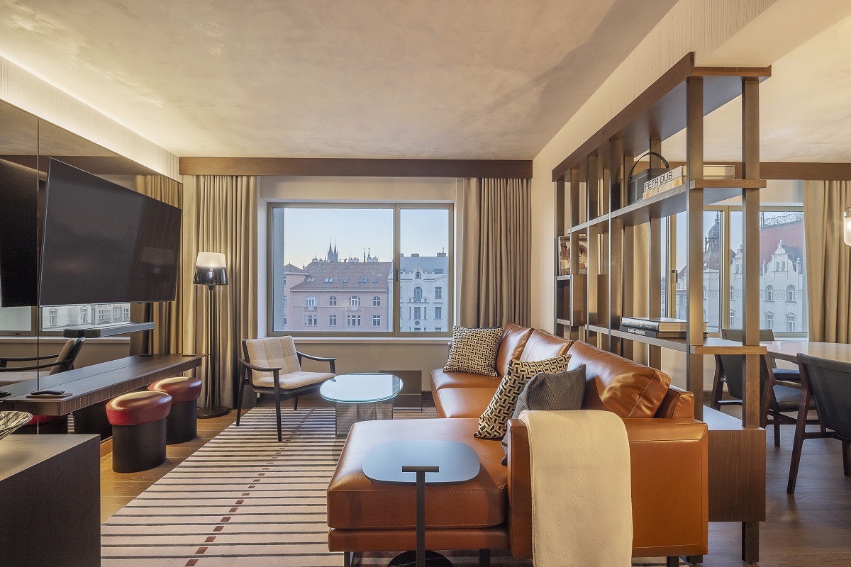 leather couch and wooden tables in hotel signature suite