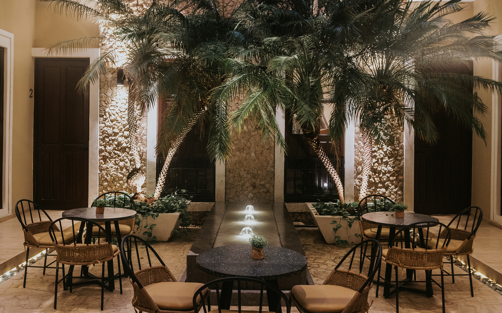 internal courtyard at Kahal with palm trees and fountain