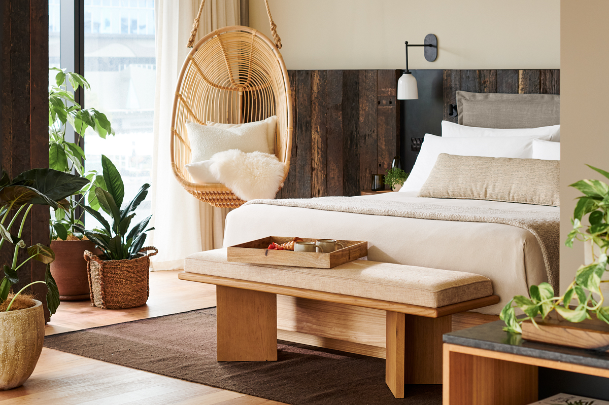 hanging cane chair and plants in guestroom of ! Hotel Melbourne