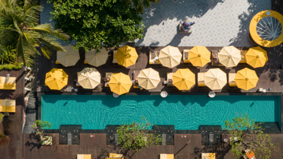 aerial view of yellow umbrellas around pool Hyde Bali