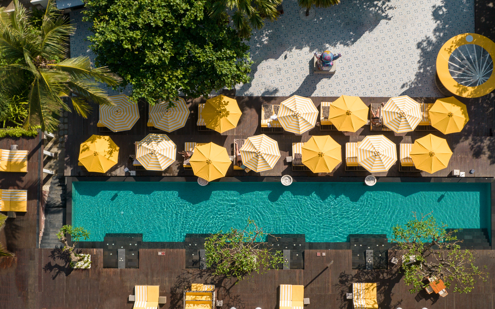 aerial view of yellow umbrellas around pool Hyde Bali