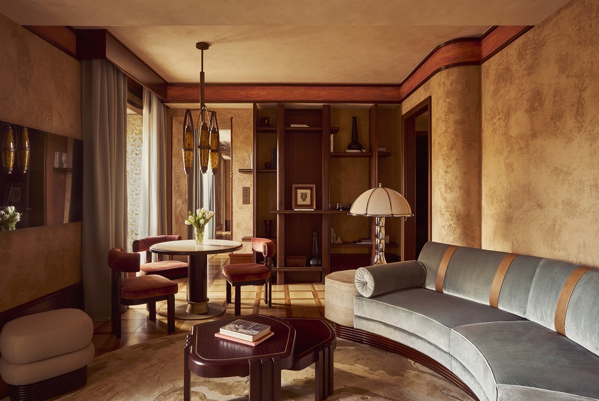 curved blue couch in suite living room of Orient Express La Minerva