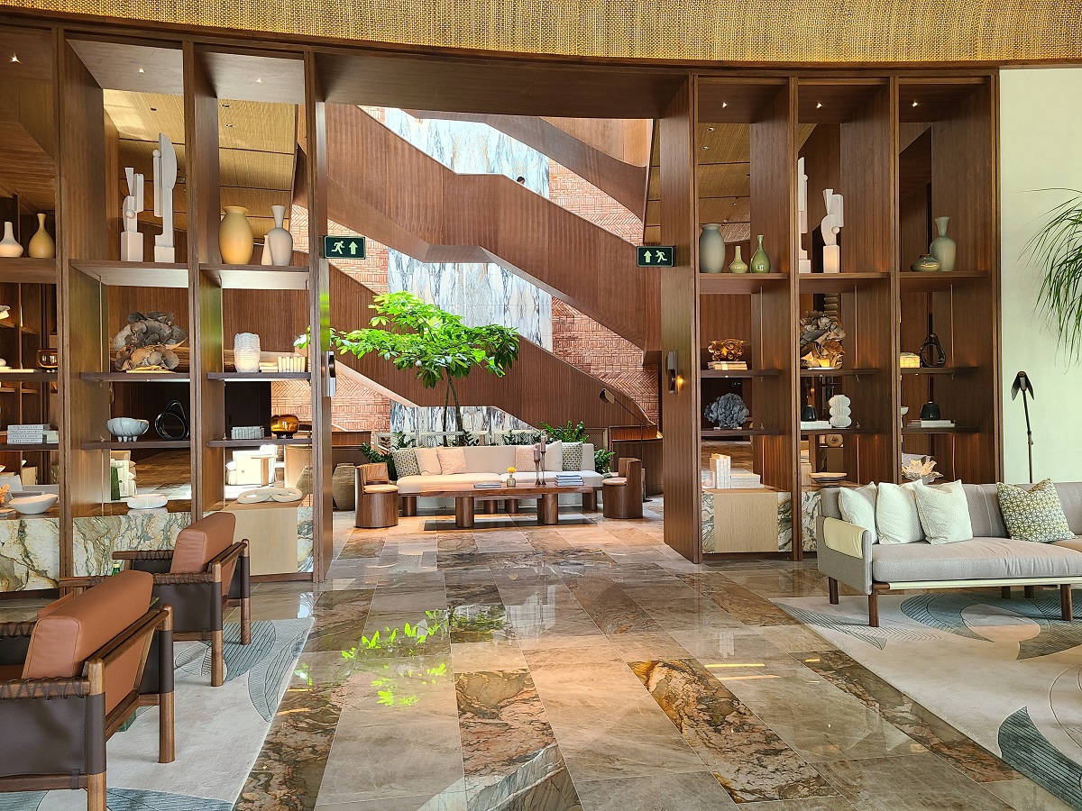 view through hotel lobby to sculptural staircase