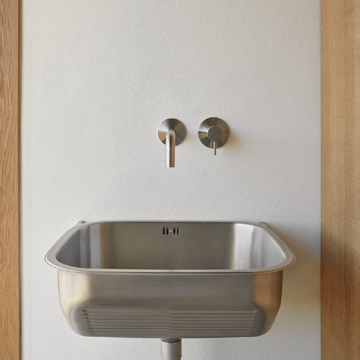 stainless steel wash basin with minimalist wall mounted taps