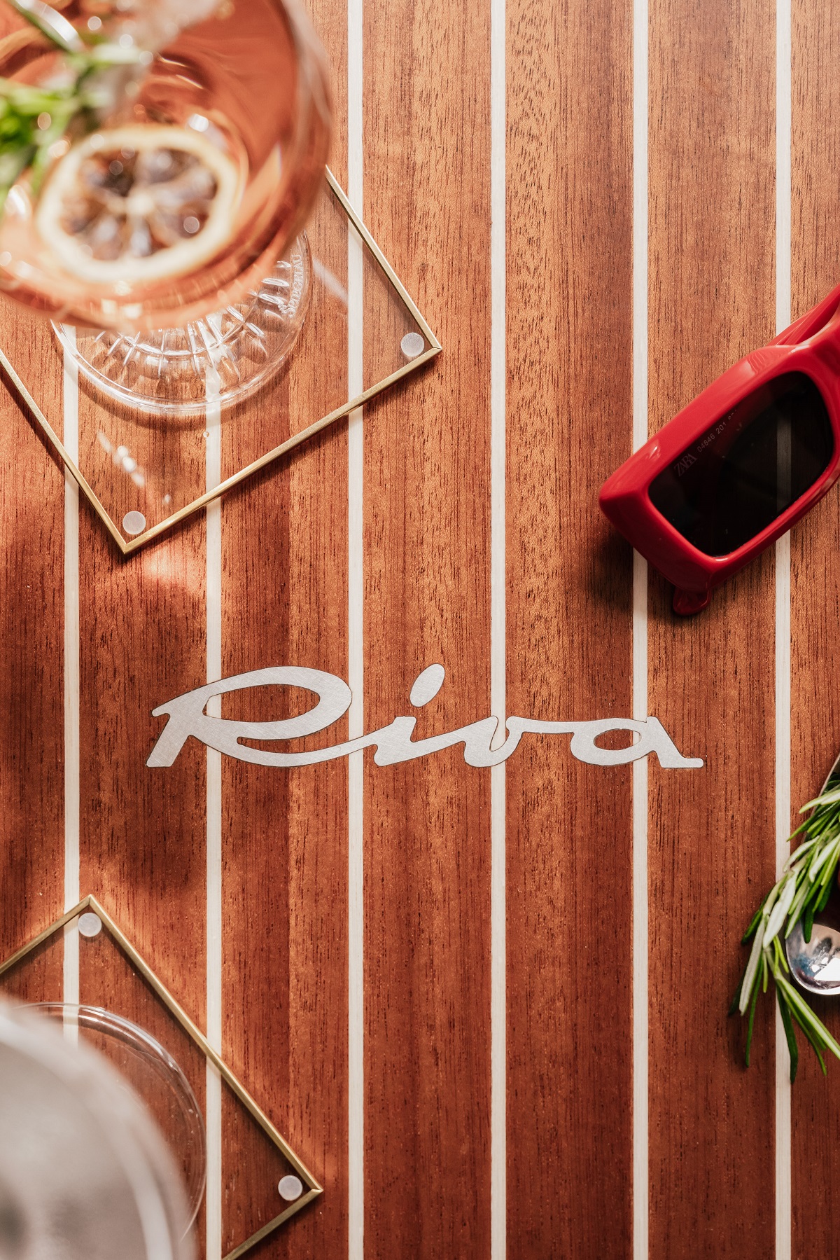 cocktail glasses and sunglasses on a Riva deck