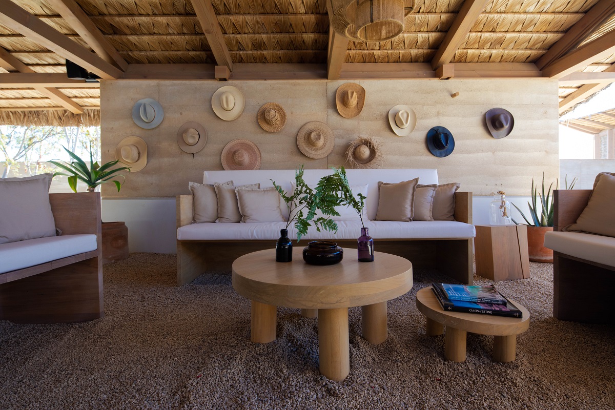 hats on a wooden wall behind organic wooden furniture