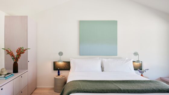 double bed with throw in guestroom at The three ducks hotel