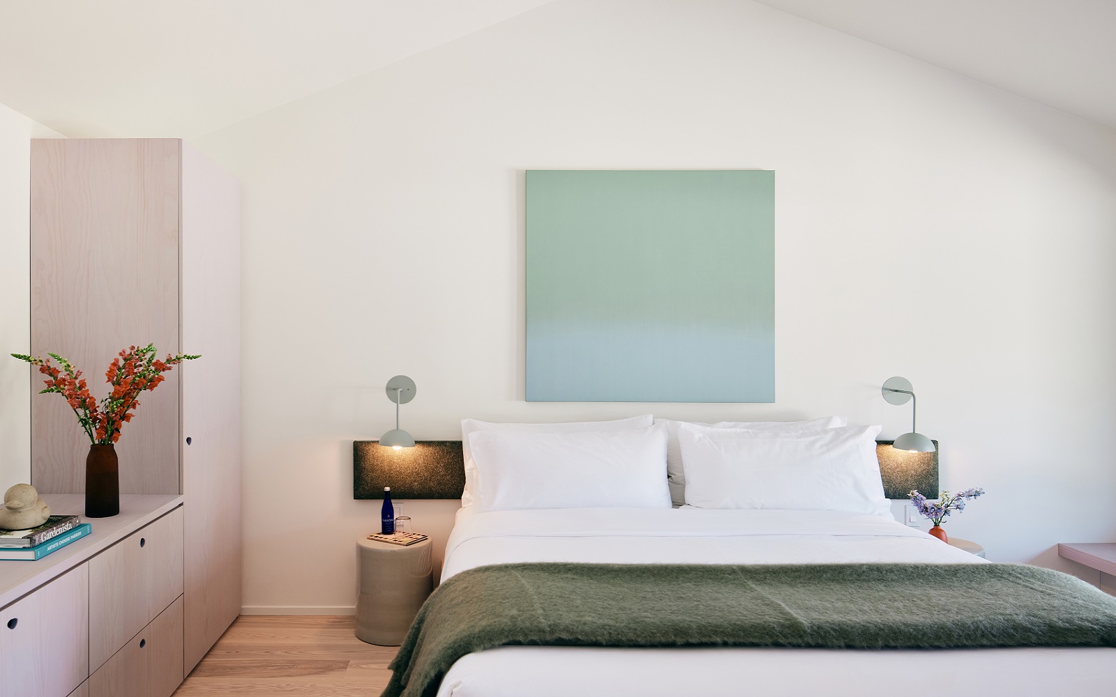 double bed with throw in guestroom at The three ducks hotel
