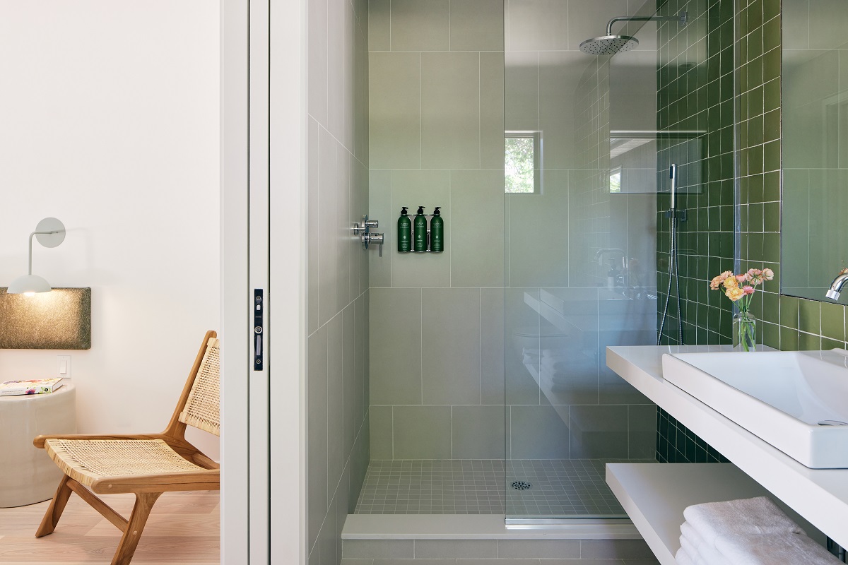 sage green, white and wood in the guestroom and shower