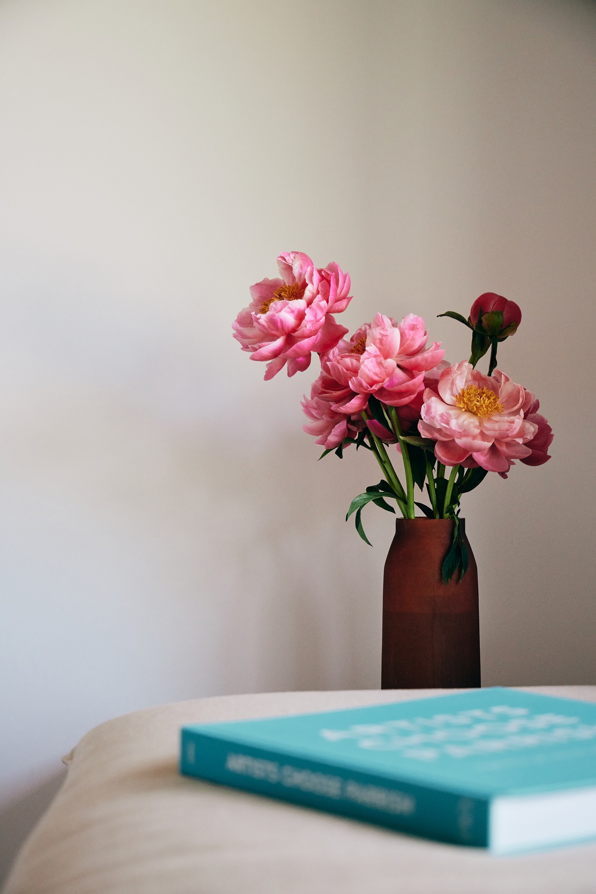 blue poetry book and pink flowers in guestroom at The three ducks