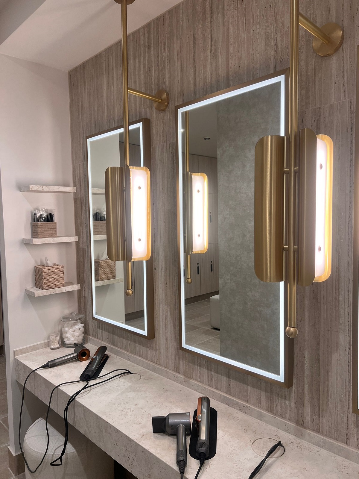 led lit bathroom mirrors above vanity with hairdryers