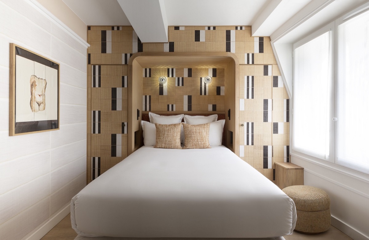 patterned panelling behind bed in hotel drouot guestroom