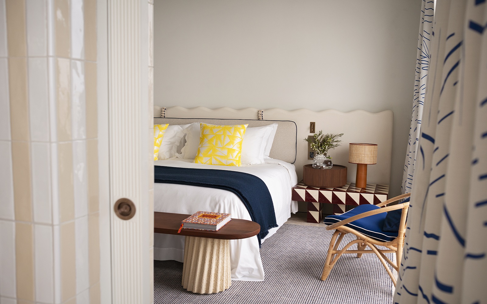 bed with blue throw and yellow cushions in Jumeirah Capri Palace