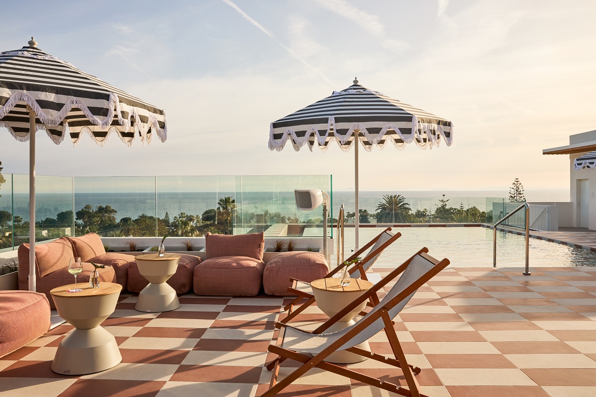 chequerboard tiles and striped umbrellas around pool