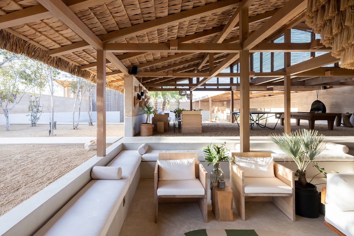 wooden furniture under thatched roof in open space
