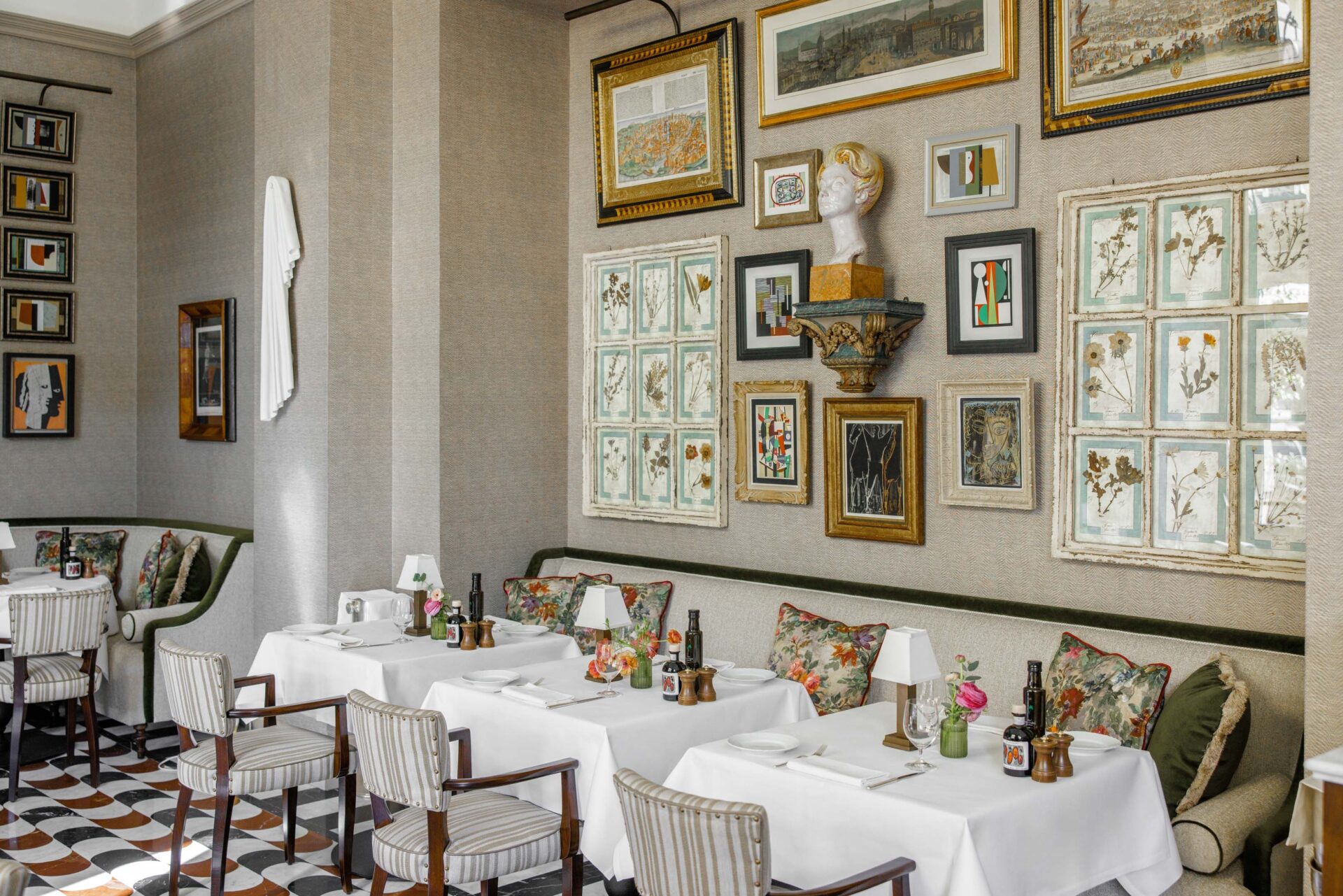 Restaurant space at Hotel Savoy, with brightly coloured gallery wall and large glass chandelier