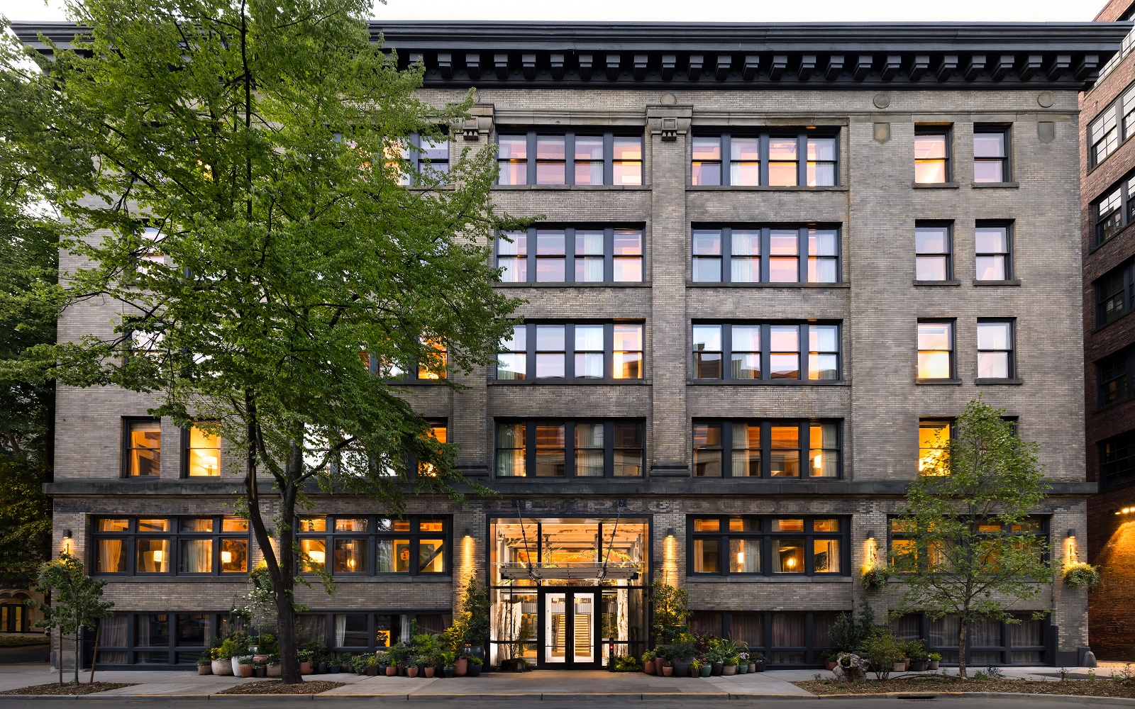 exterior facade of Populus Seattle, a carbon positive hotel in Seattle’s historic Pioneer Square