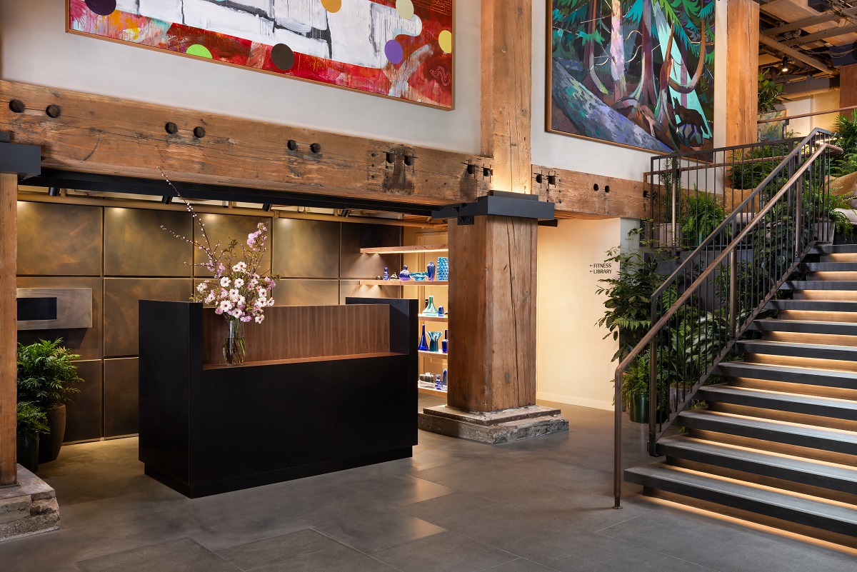 wooden reception desk with wooden beams and plants