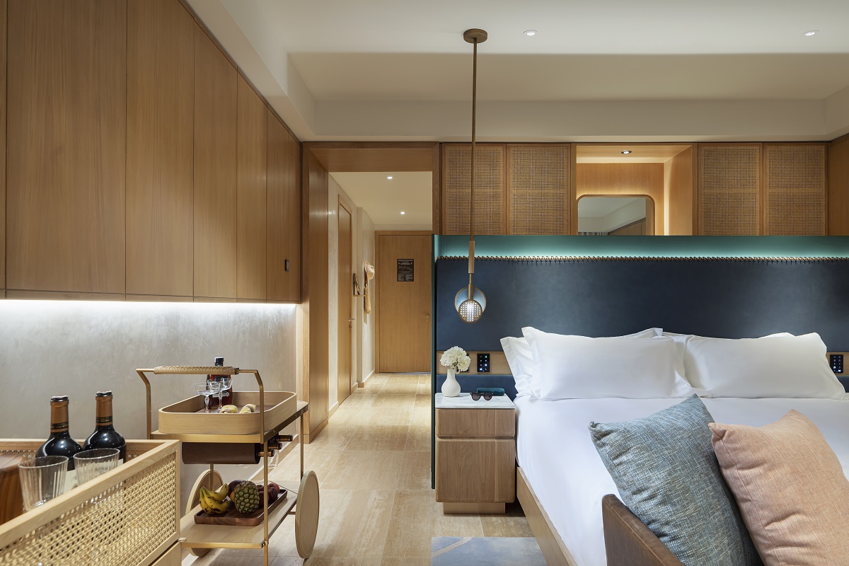 wood panelling, blue headboard and marble floor in Cap Cana guestroom