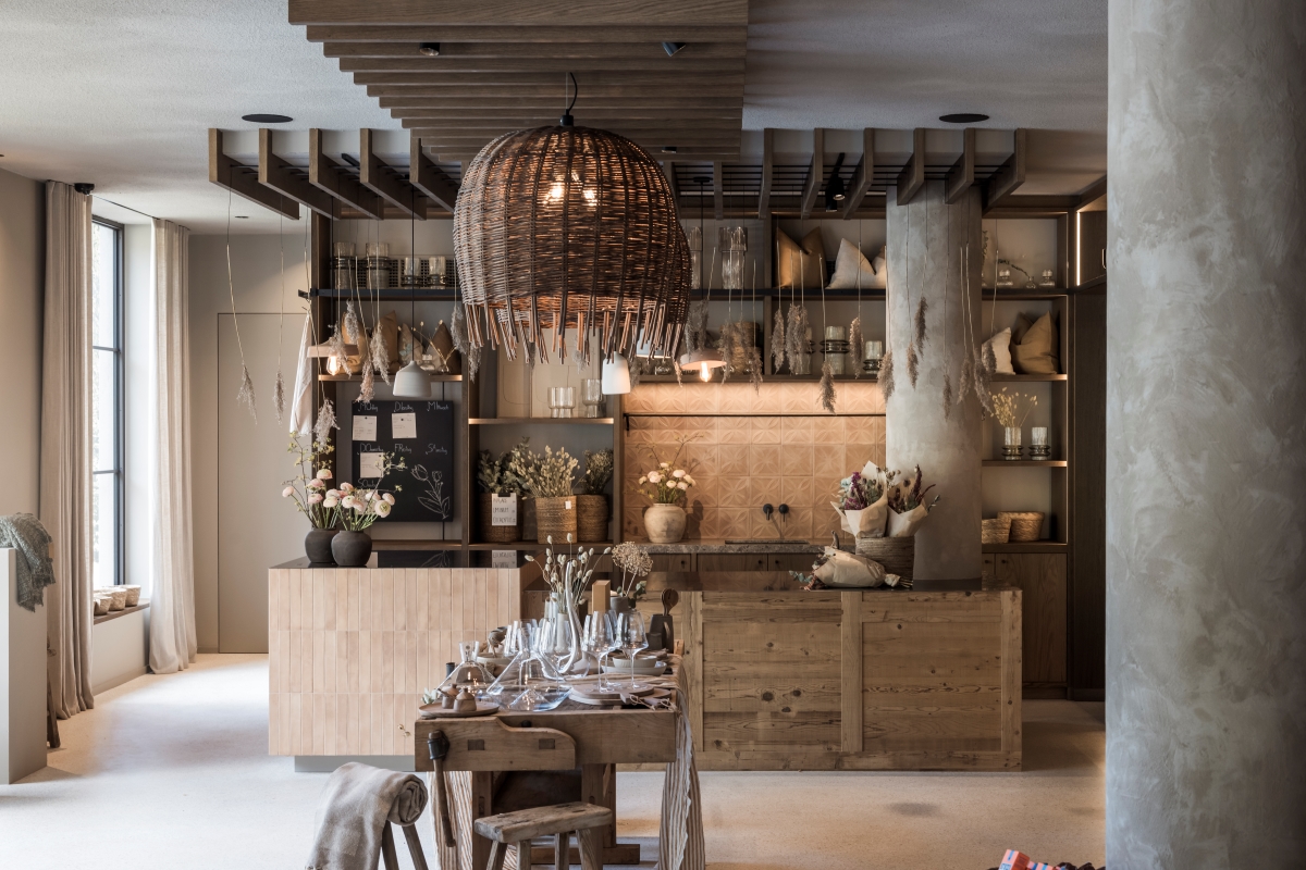 Wall of The Barn by NOA lined with shelving and unique objects