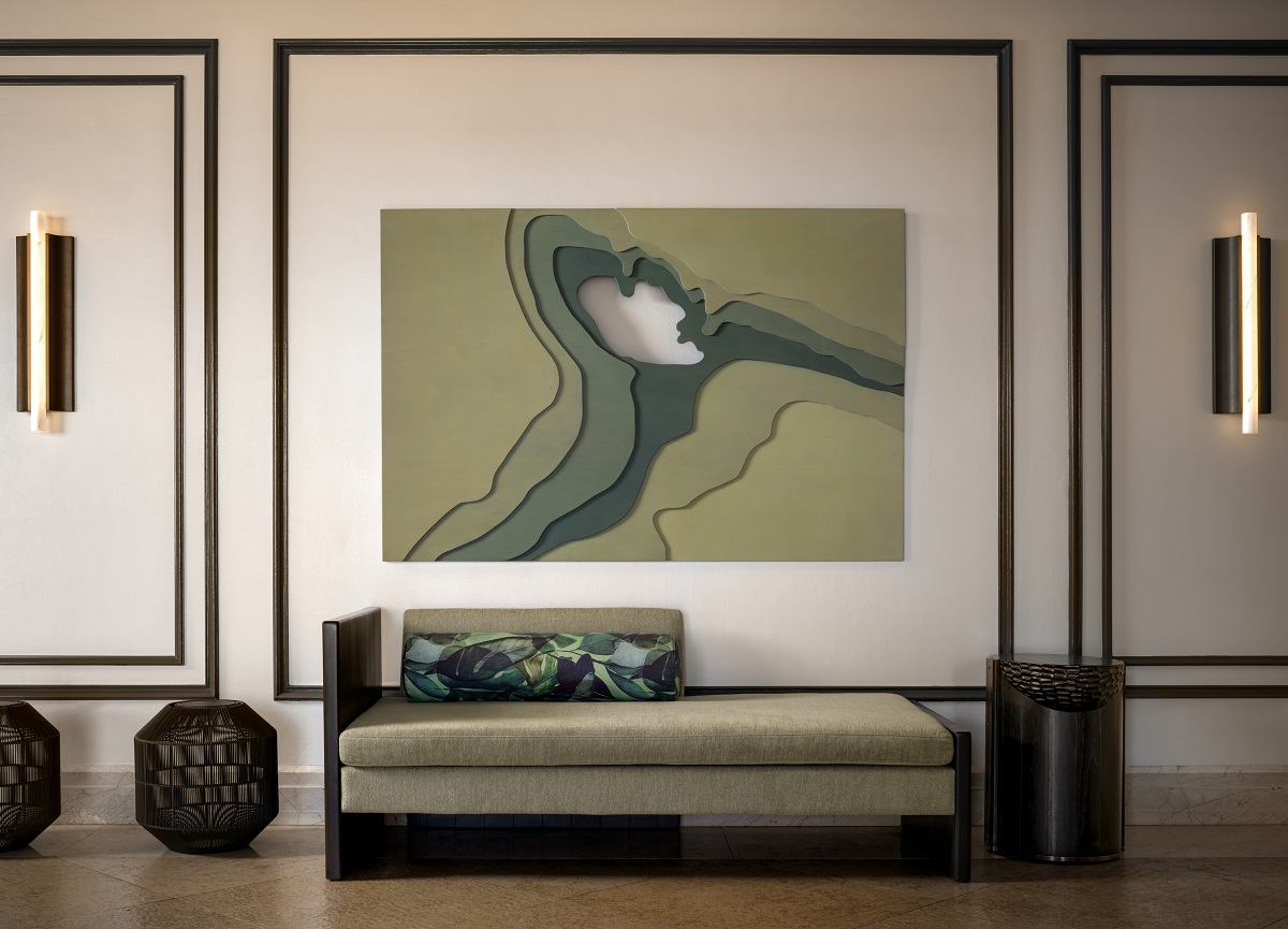 wall size abstract art behind minimalist couch in Fairmont Orchid lobby