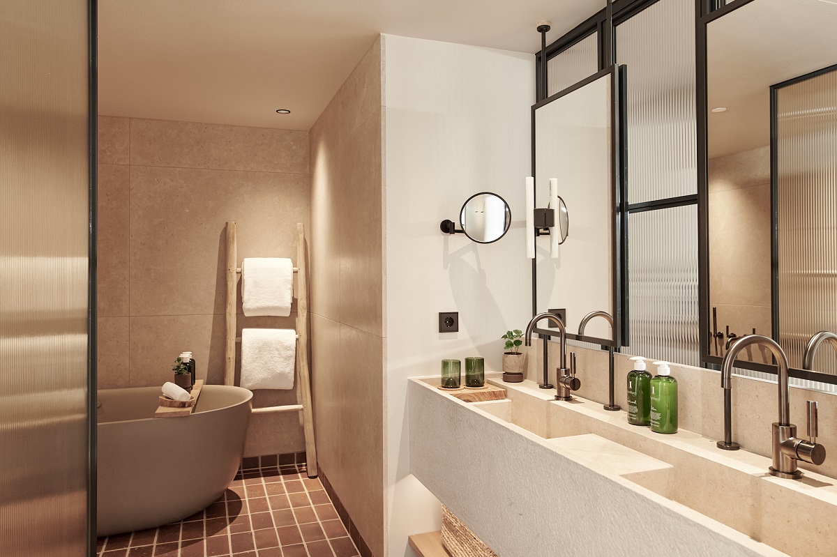 cream and stone bathroom with freestanding bath