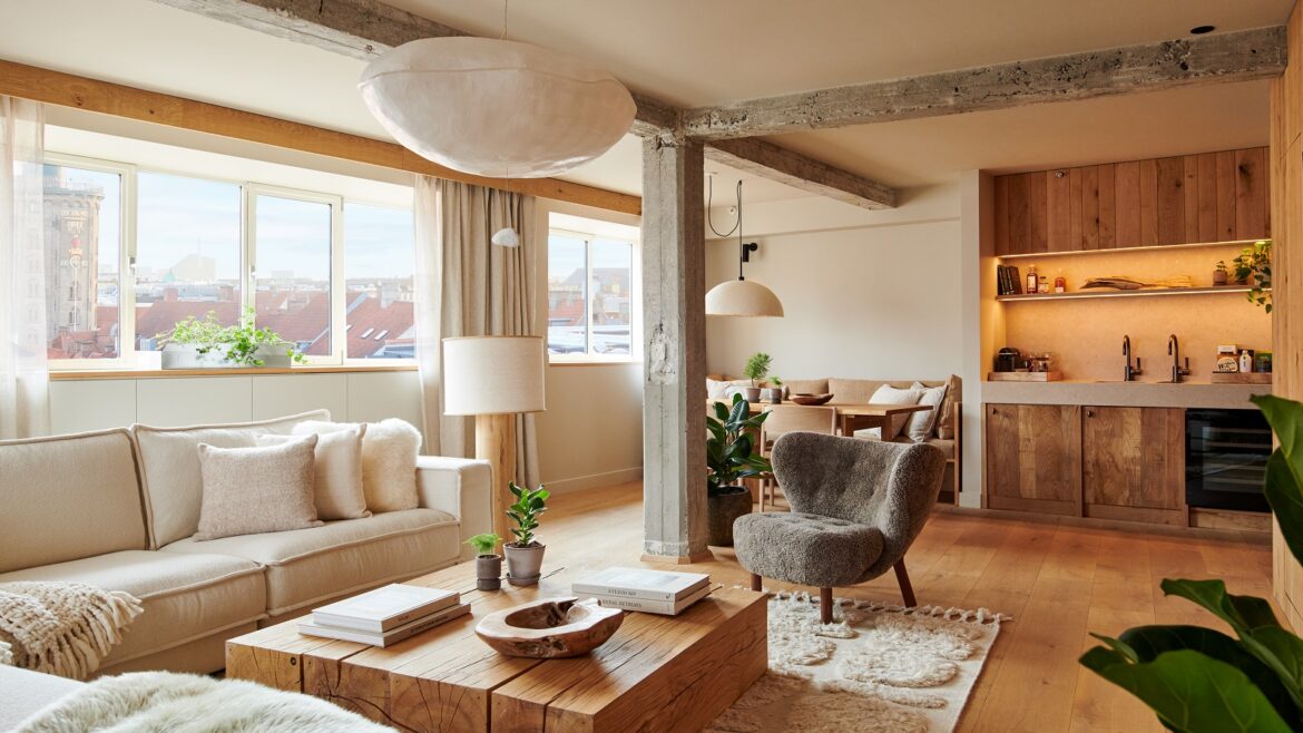 wooden coffee table and cream couches in suite at 1 Hotel Copenhagen