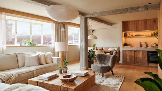 wooden coffee table and cream couches in suite at 1 Hotel Copenhagen
