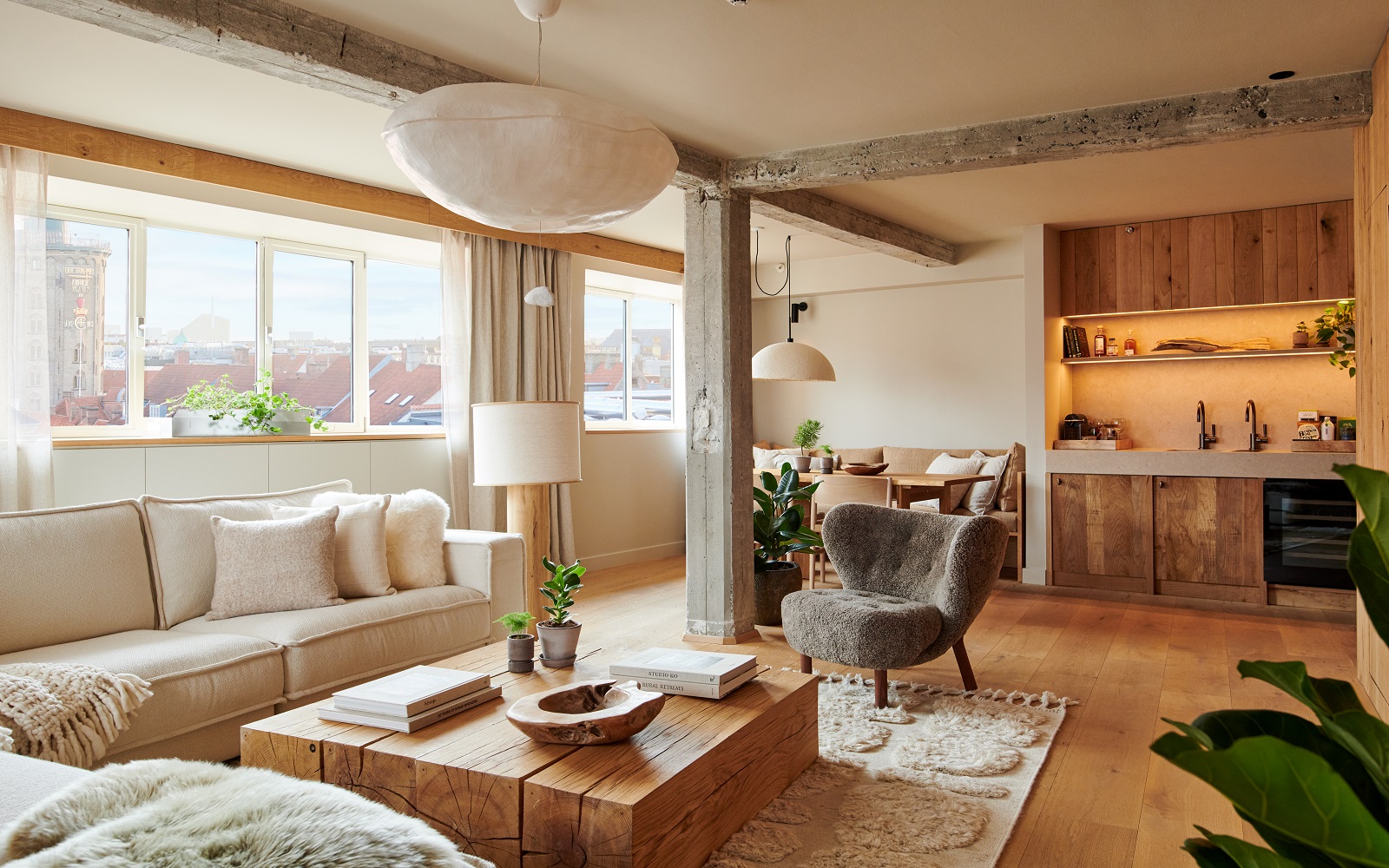 wooden coffee table and cream couches in suite at 1 Hotel Copenhagen