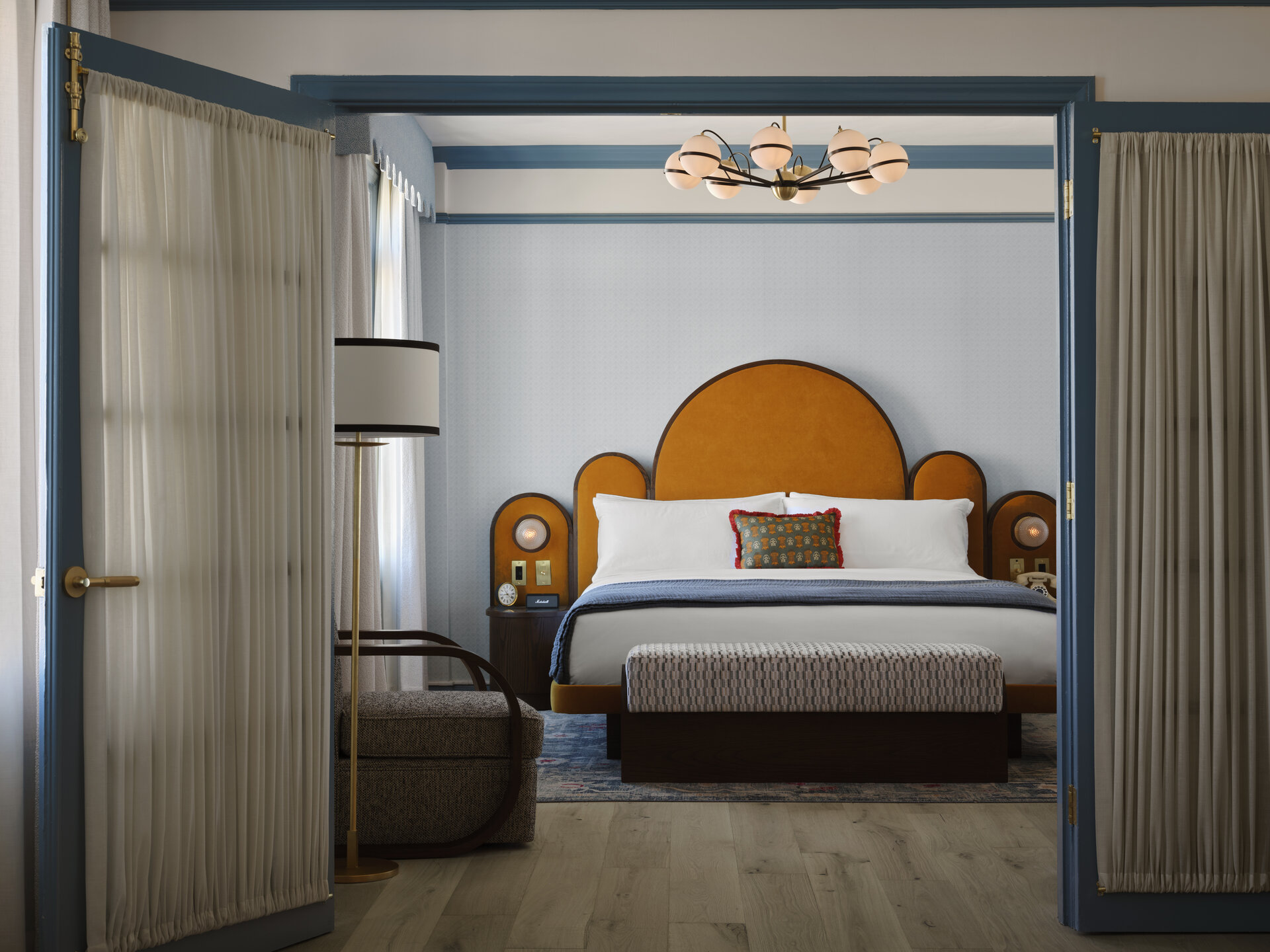 Blue bedroom with darker blue details and rich chestnut bed headboard