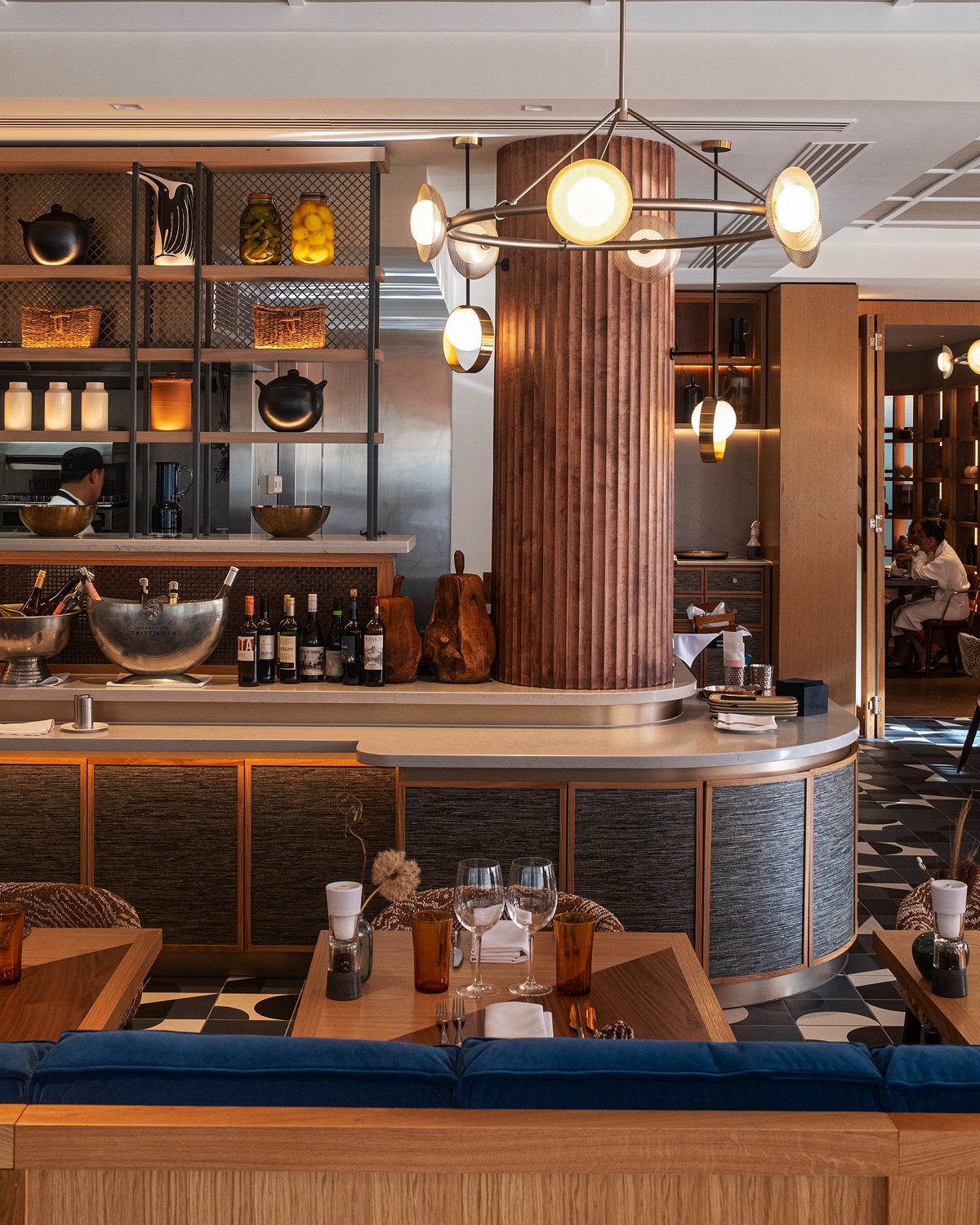 fluted wooden pillar, curved bar and blue banquette