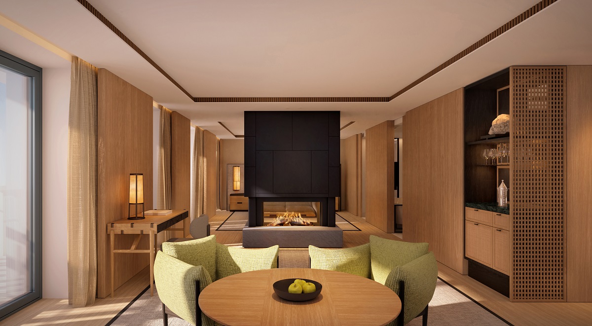 light wood table and panelling and green chairs in Aman Alpina suite