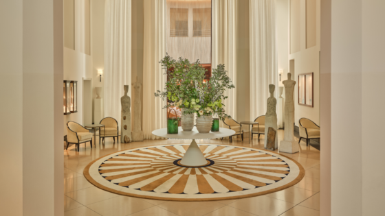 Lobby of The Charles Rocco Forte Hotel, with central table with floral arrangement and intricate circular pattern floor