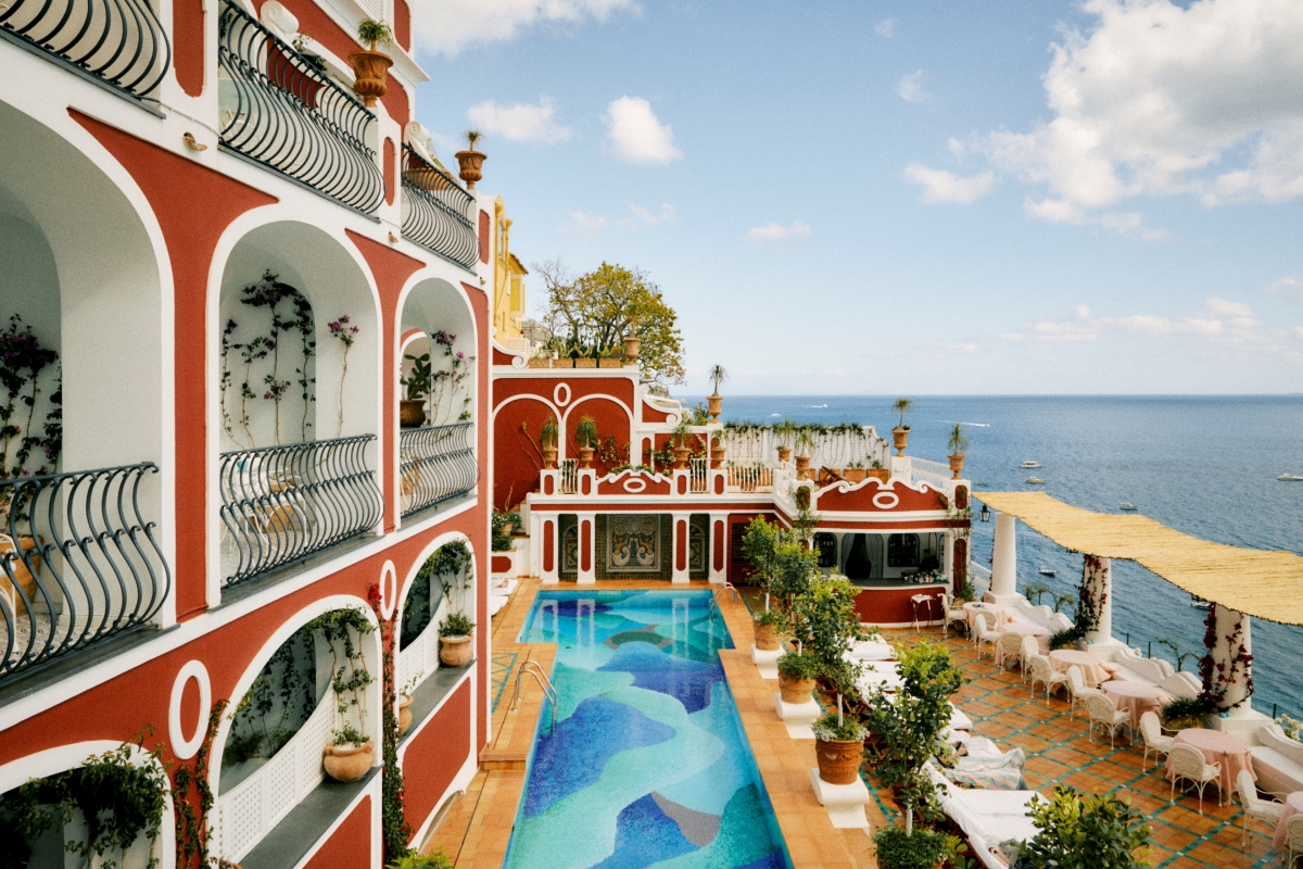 Bright red exterior of Le Sirenuse hotel in Positano with outdoor pool with mosaic, water-coloured base, from The Leading Hotels of the World new book