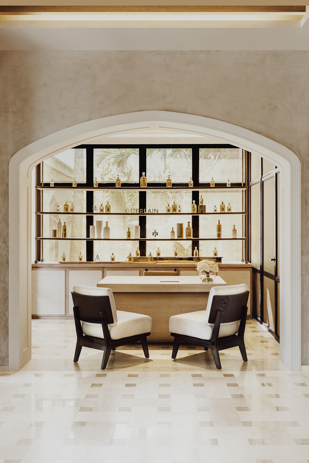 table and chair in front of backlit products in spa