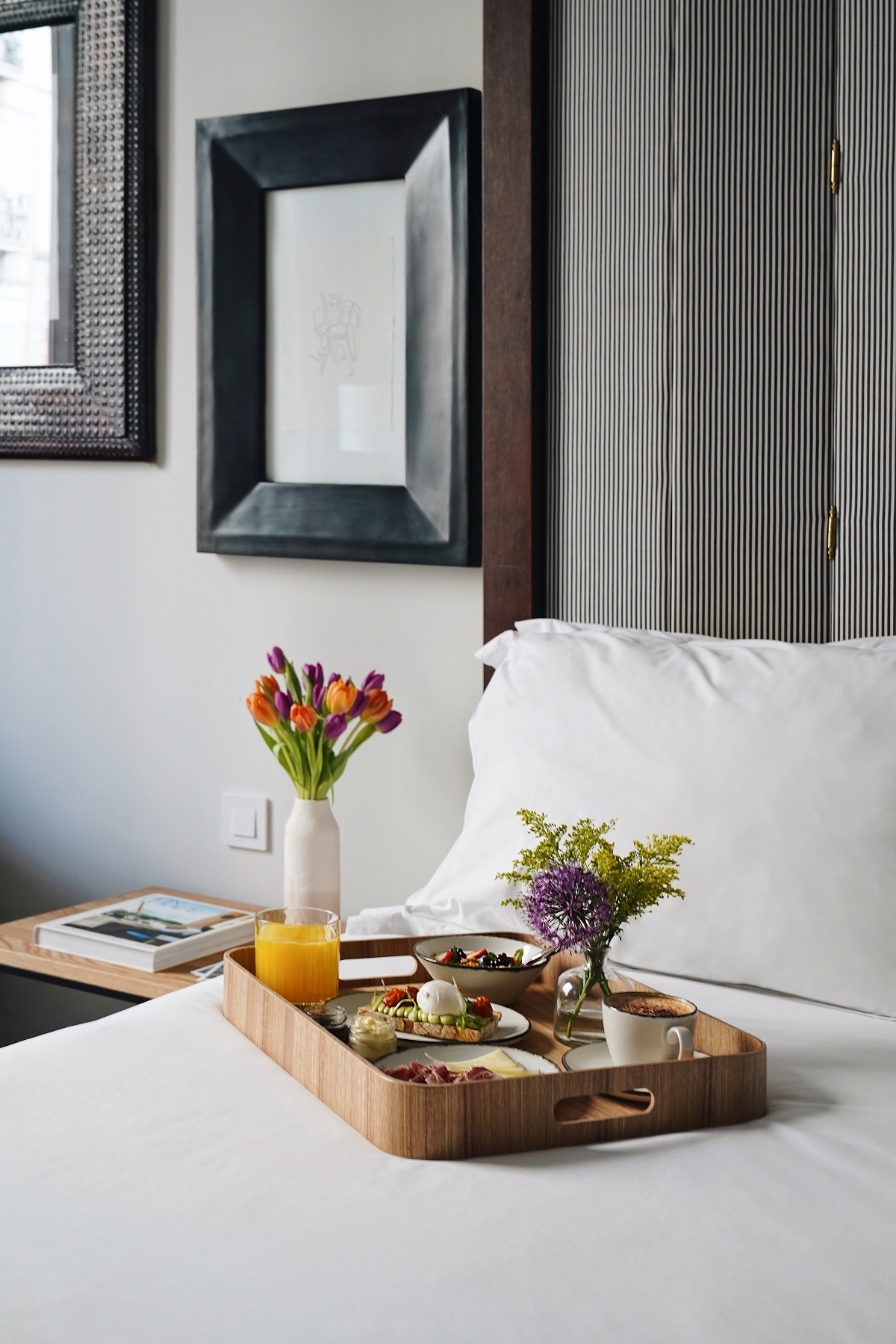 breakfast tray on bed in hotel guestroom