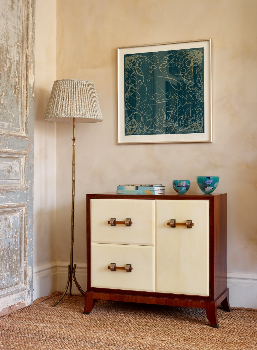 Richard Allan London Elegance scarf design framed on wall above cream mid-century cabernet